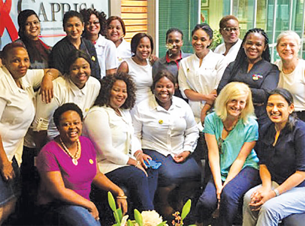 Dr. Jennifer Zelnick (bottom row, second from right) trains South African social workers to create a better experience for patients with drug-resistant TB and HIV.