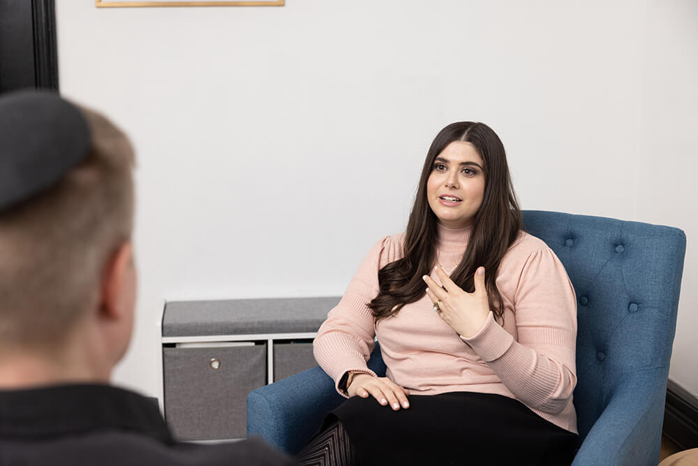 Female social worker Esti Marcus conducting a therapy session with male patient