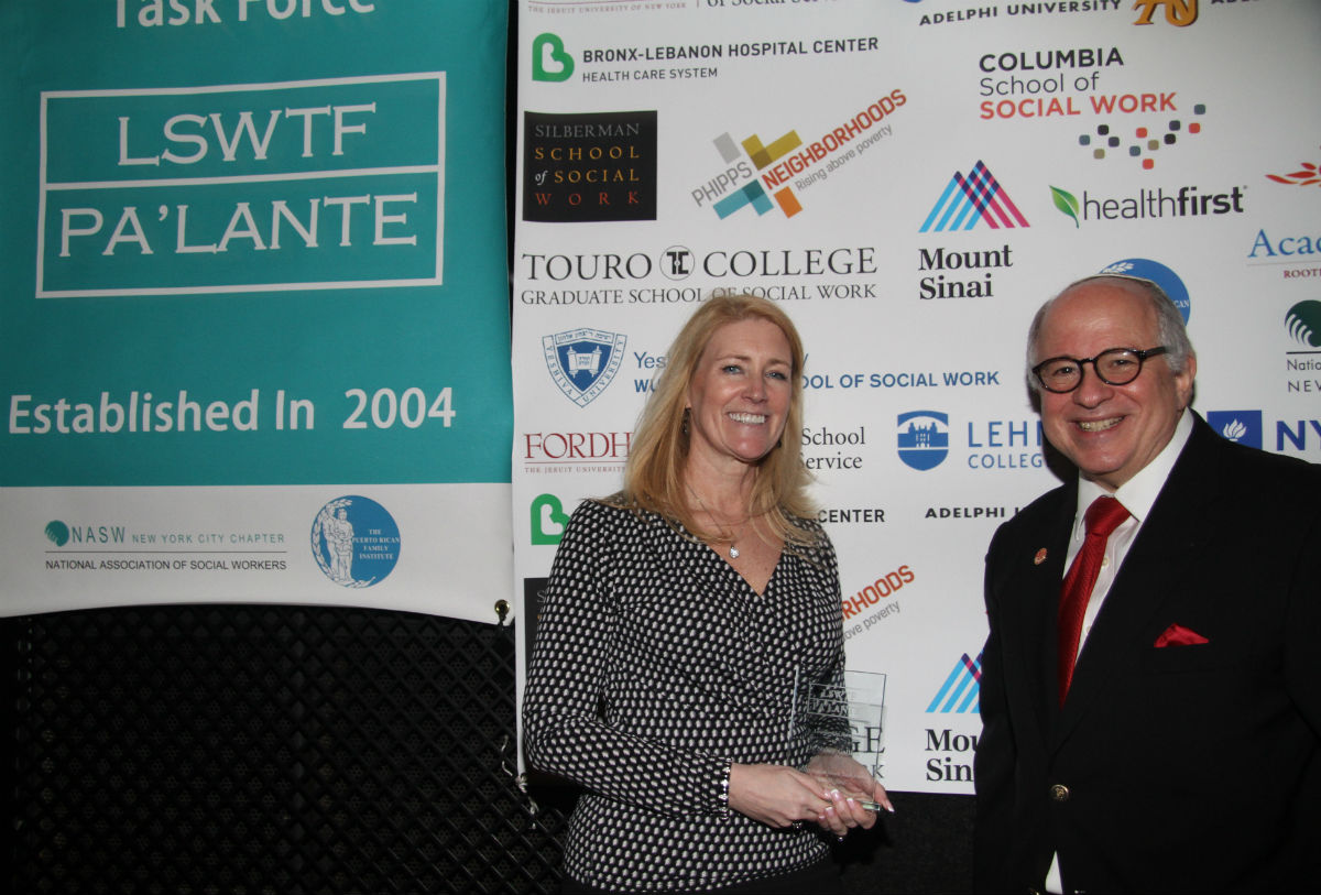 L-r: Associate Dean Nancy Gallina with her Leadership Award, and Dean Steven Huberman at Copacabana event