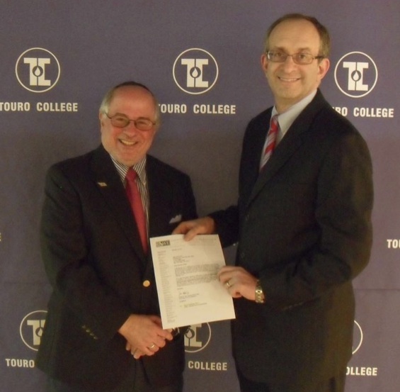 Touro College President and CEO Dr. Alan Kadish, right, congratulates Dr. Steven Huberman, founding dean of Touro College’s Graduate School of Social Work, on the School’s receiving national accreditation from The Council on Social Work Education (CSWE)