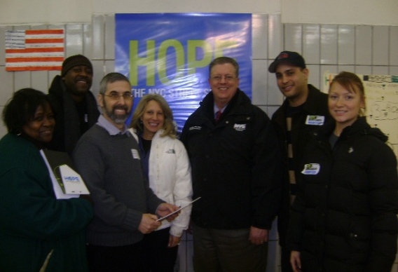 Robert V. Hess, Commissioner of the New York City Department of Homeless Services (DHS), fifth from left, meets with professor Elhanon Marvit, third from left, coordinator of the Brooklyn Division, Graduate School of Social Work at Touro College; professor Allison Bobick, fourth from left, director of student advancement; and graduate students before they set out on their volunteer assignment.